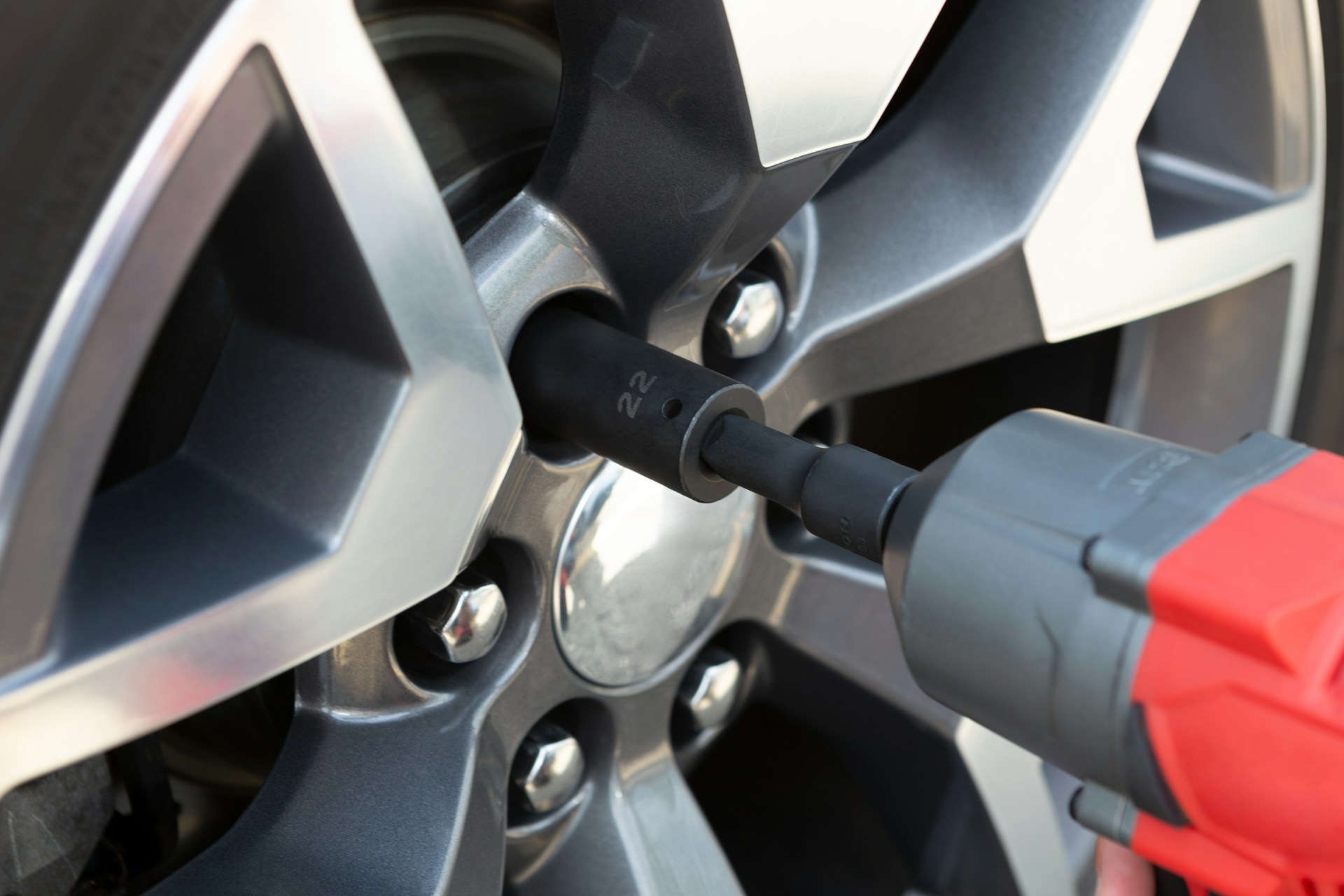 Close-up of a tire being serviced with an impact wrench during a mobile auto repair.